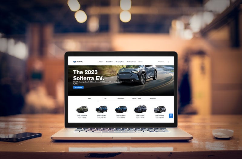 a laptop with a Subaru dealership on the screen