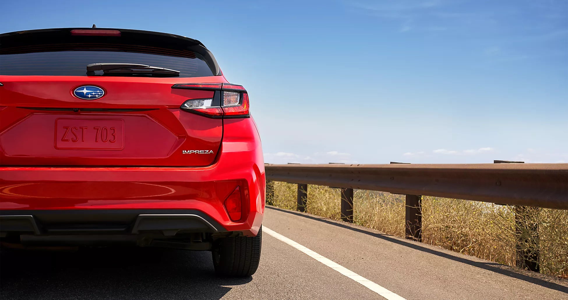 A red car driving on the road.