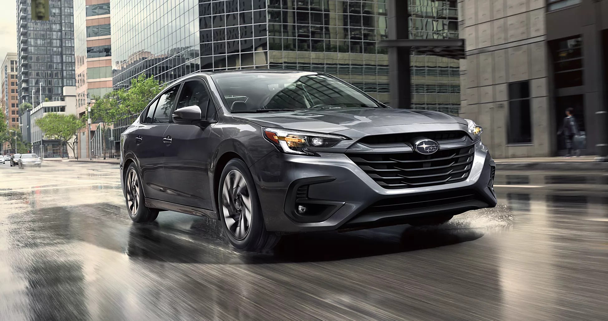 A blue car sitting parked in the road.