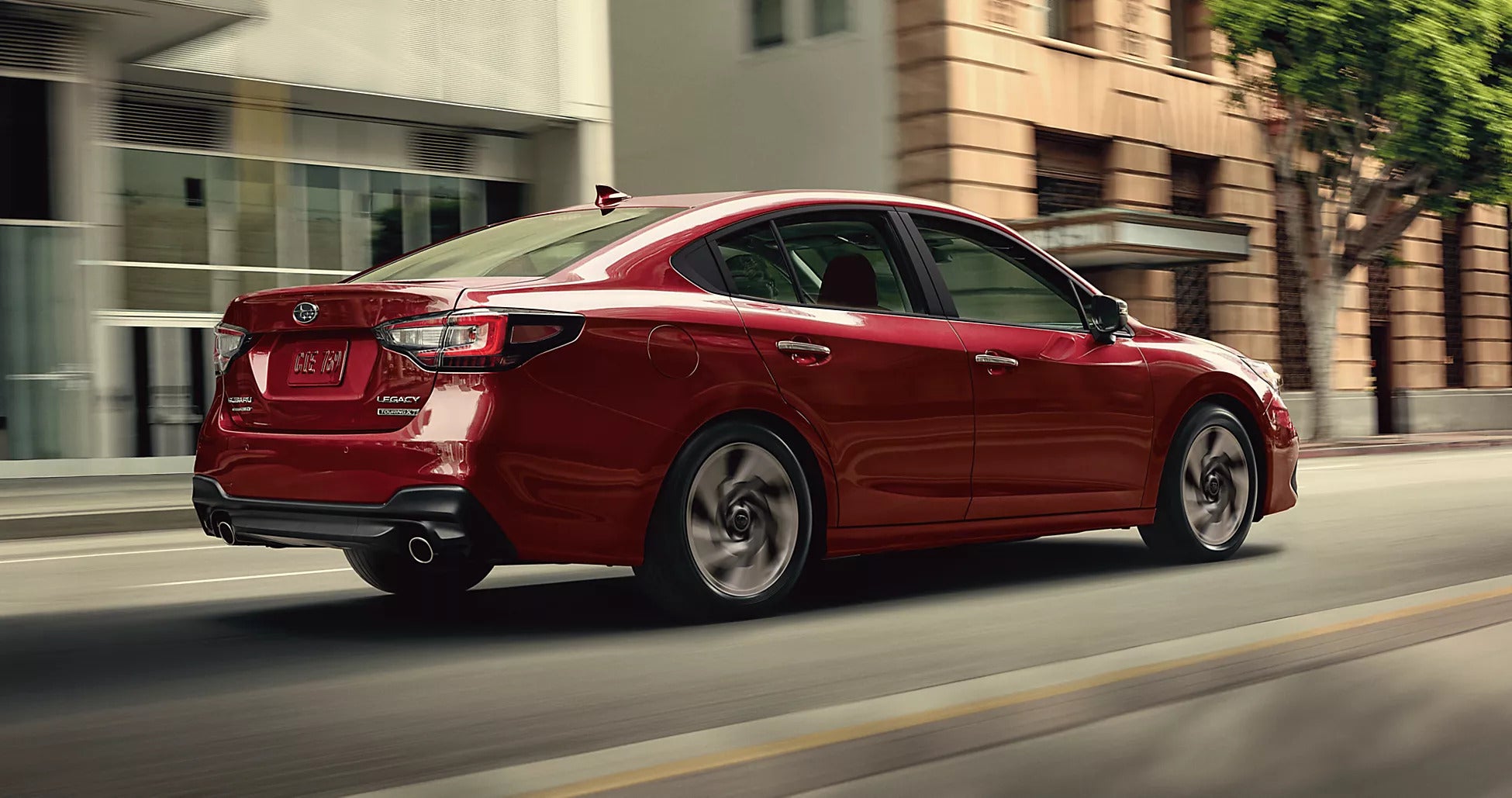 A red car driving on the road.