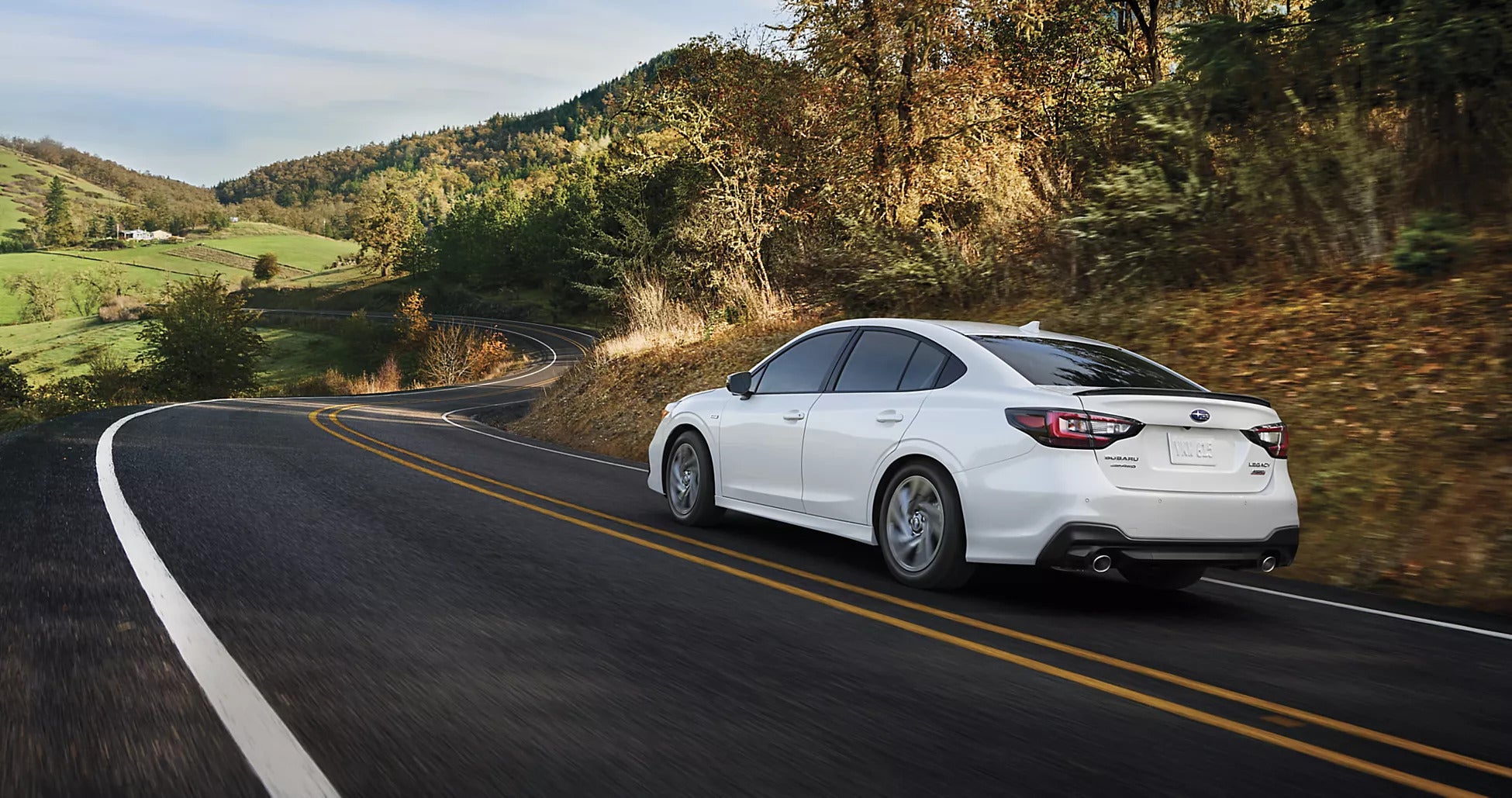 A white car driving on the road.