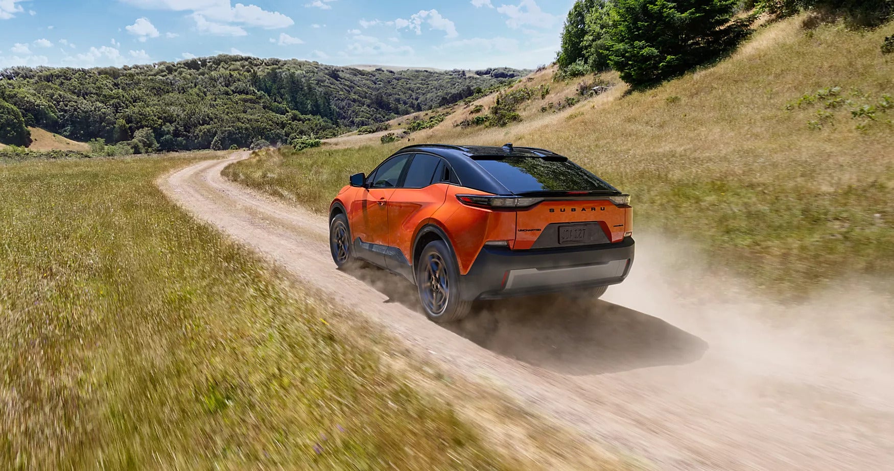 An orange car driving off-road.