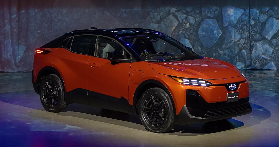 An orange car sitting parked.