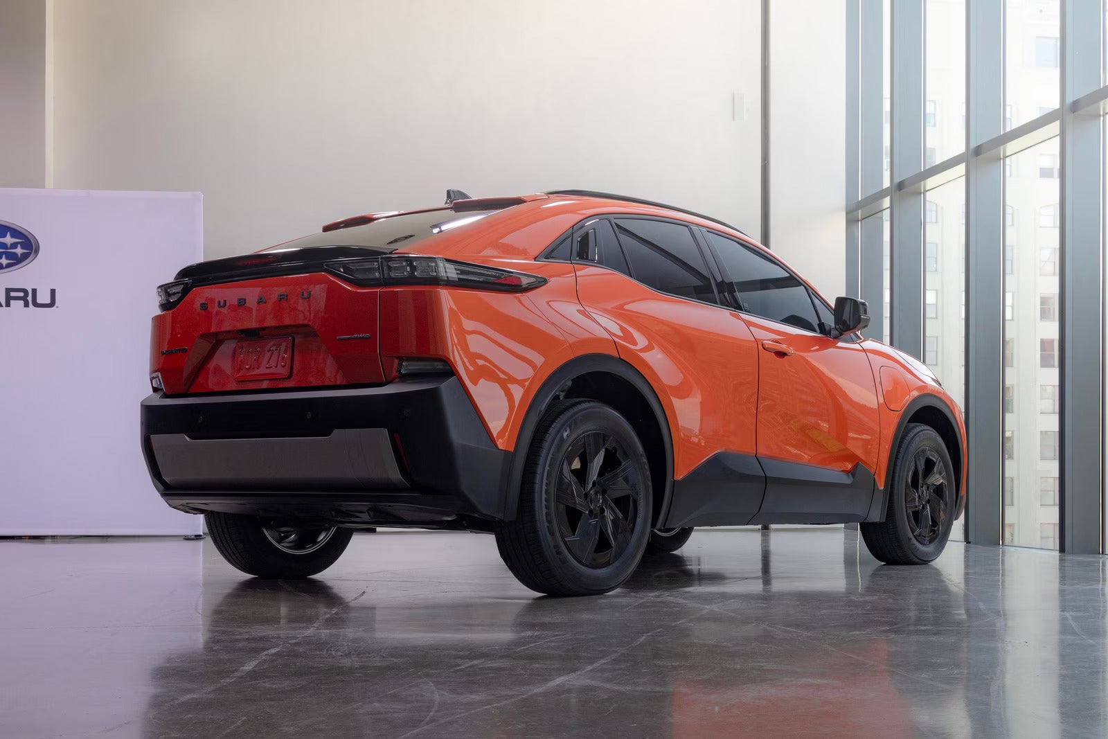 An orange car sitting parked.