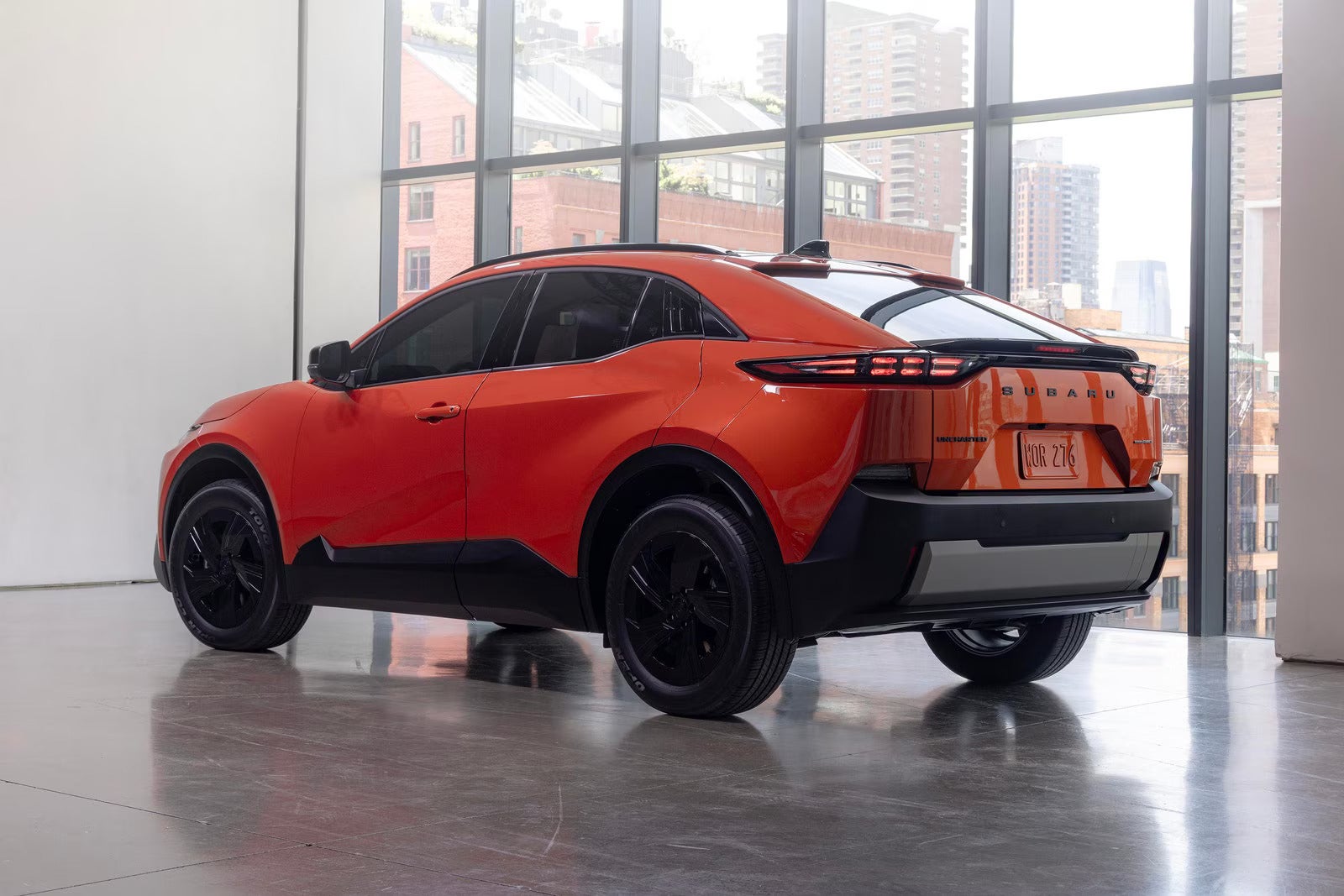 An orange car sitting parked.