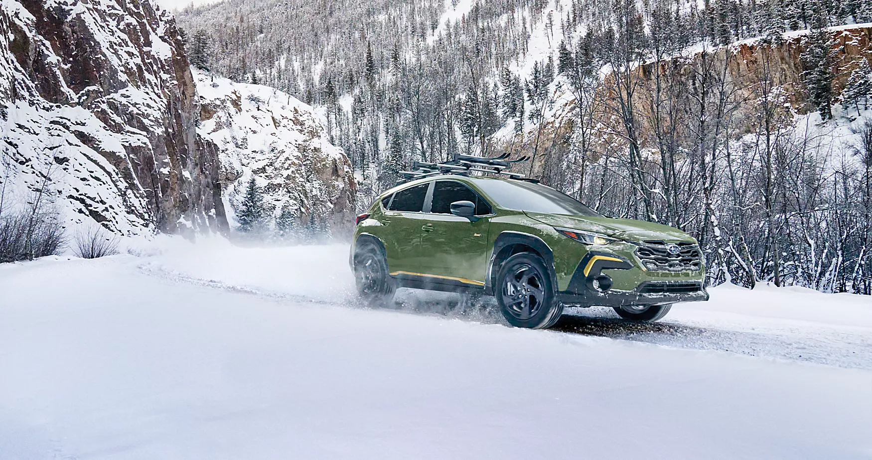 A green car driving in the snow.