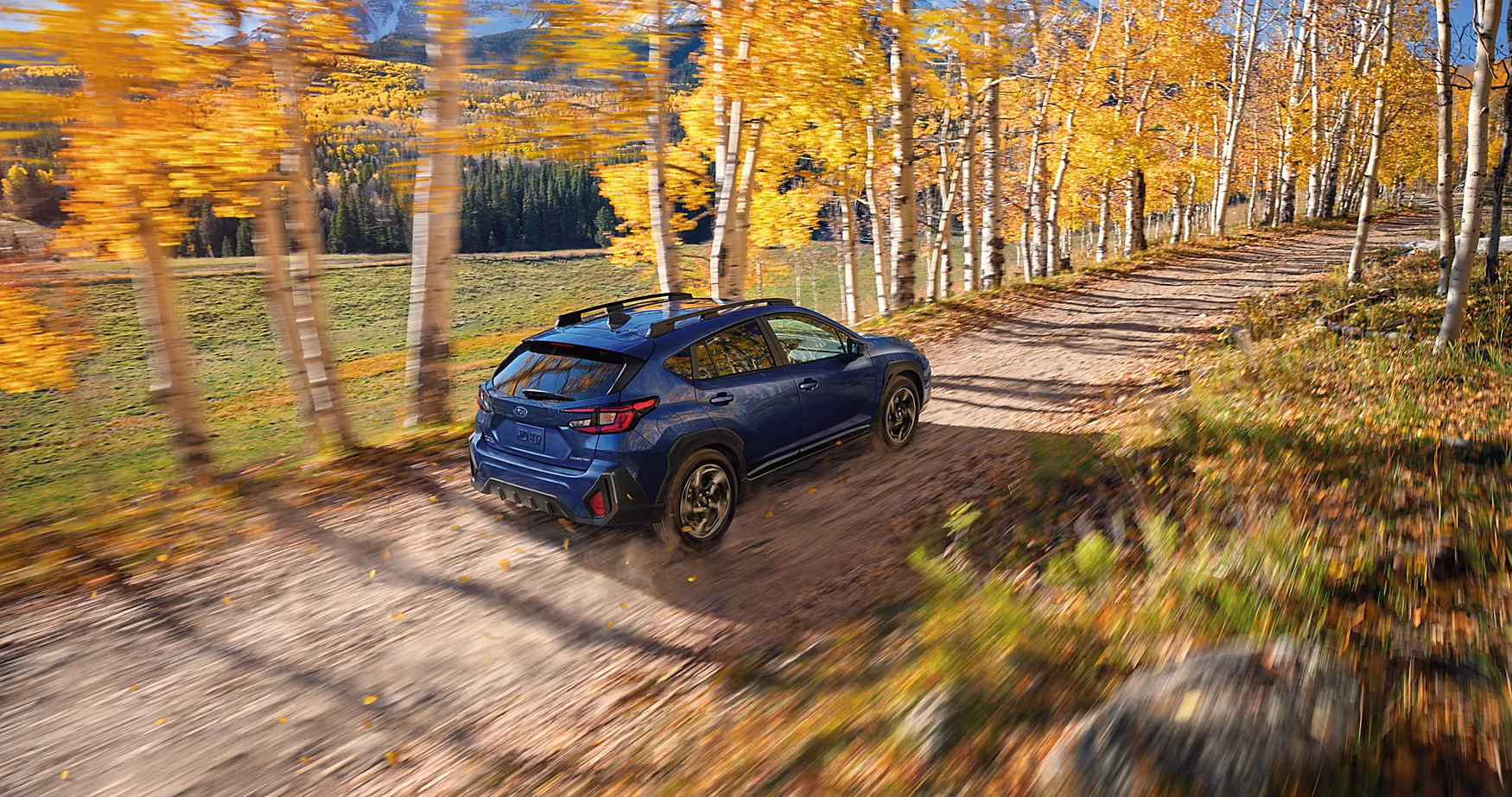 A green car driving in the snow.