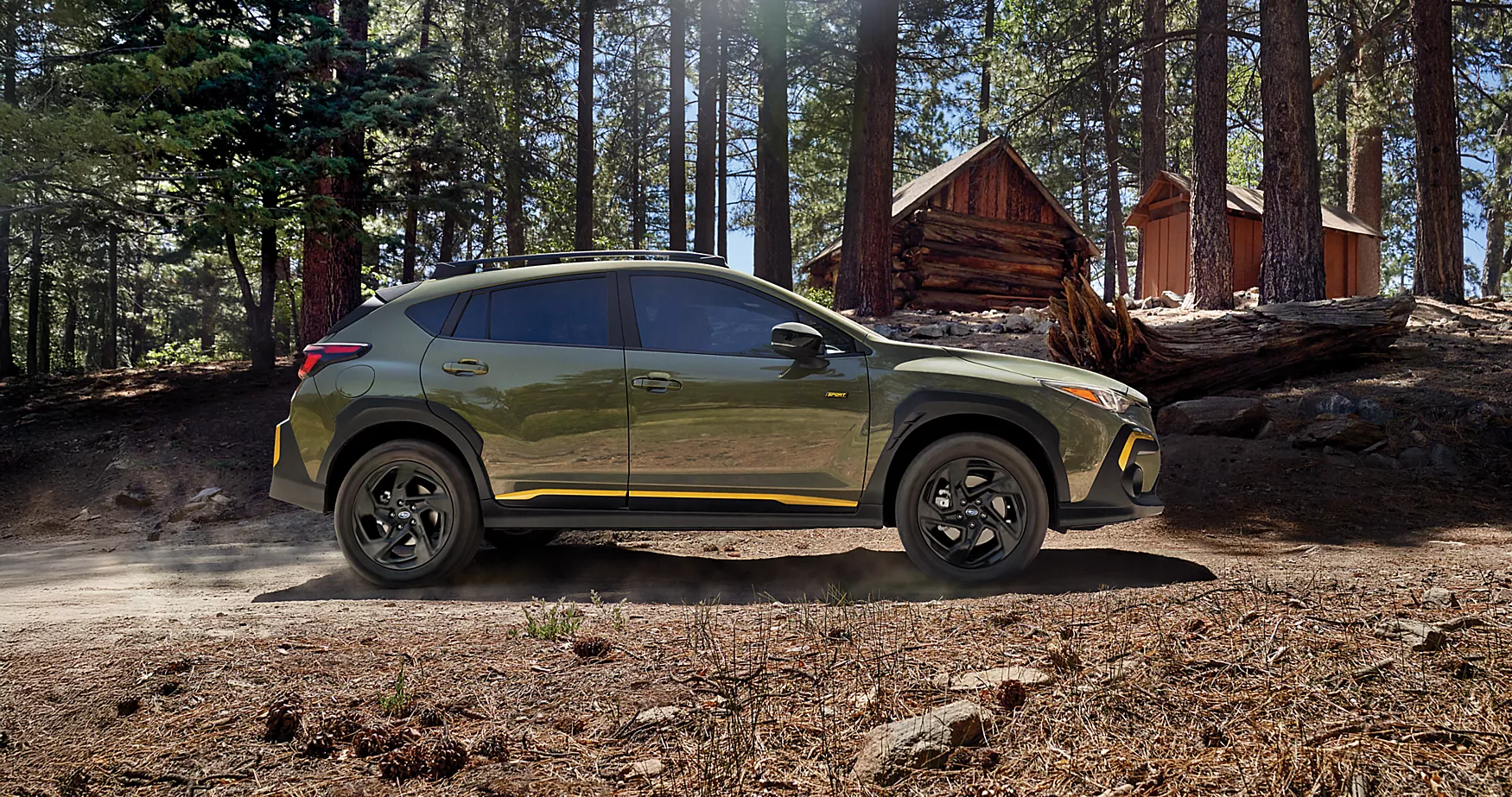 A green car driving on a dirt road.