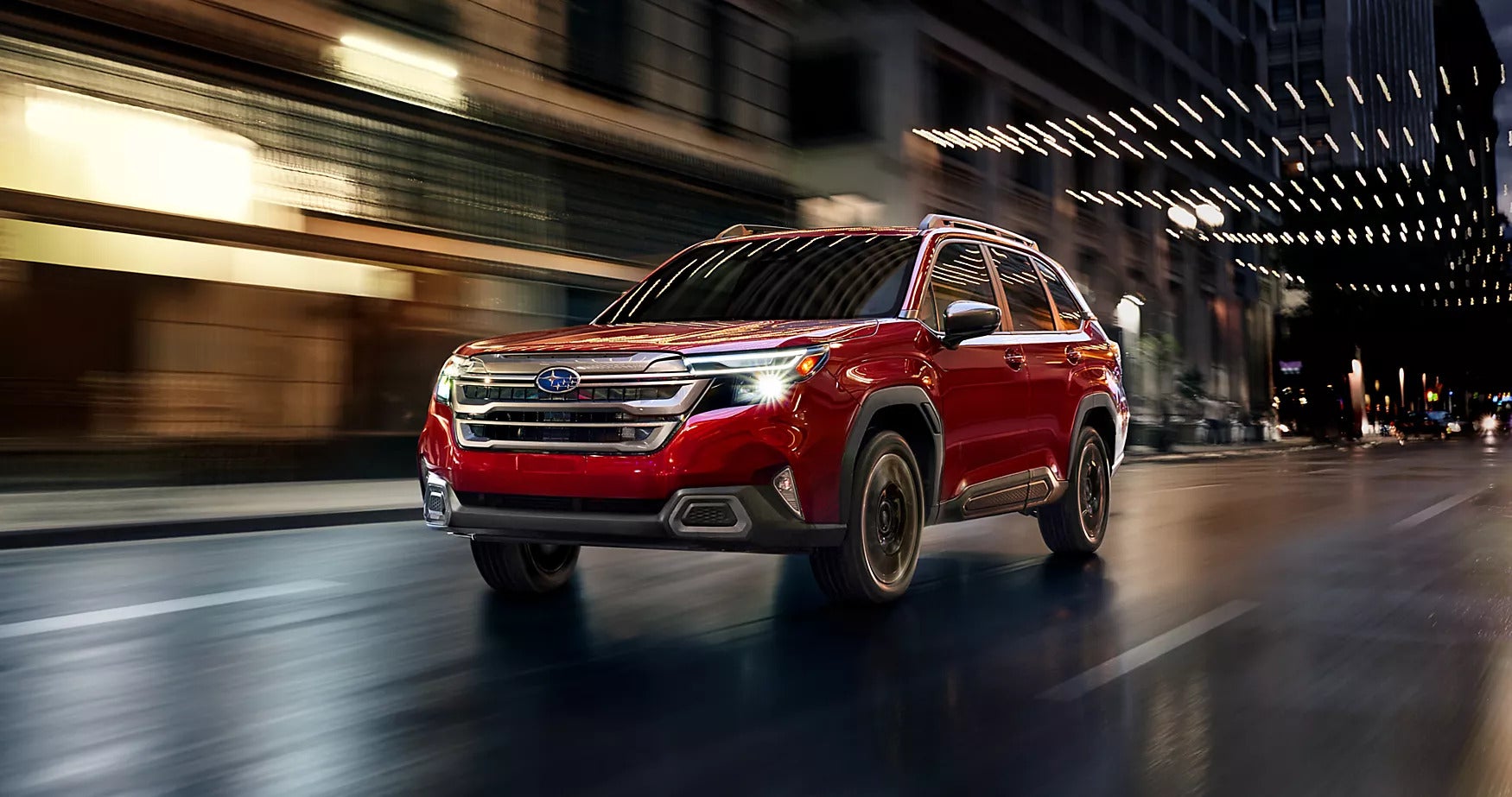a red subaru forester driving in the city