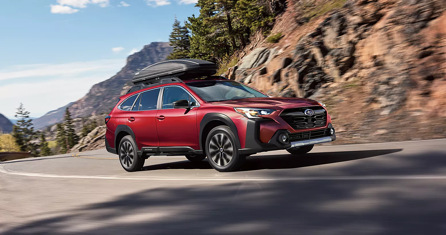 A red suv driving along a road.