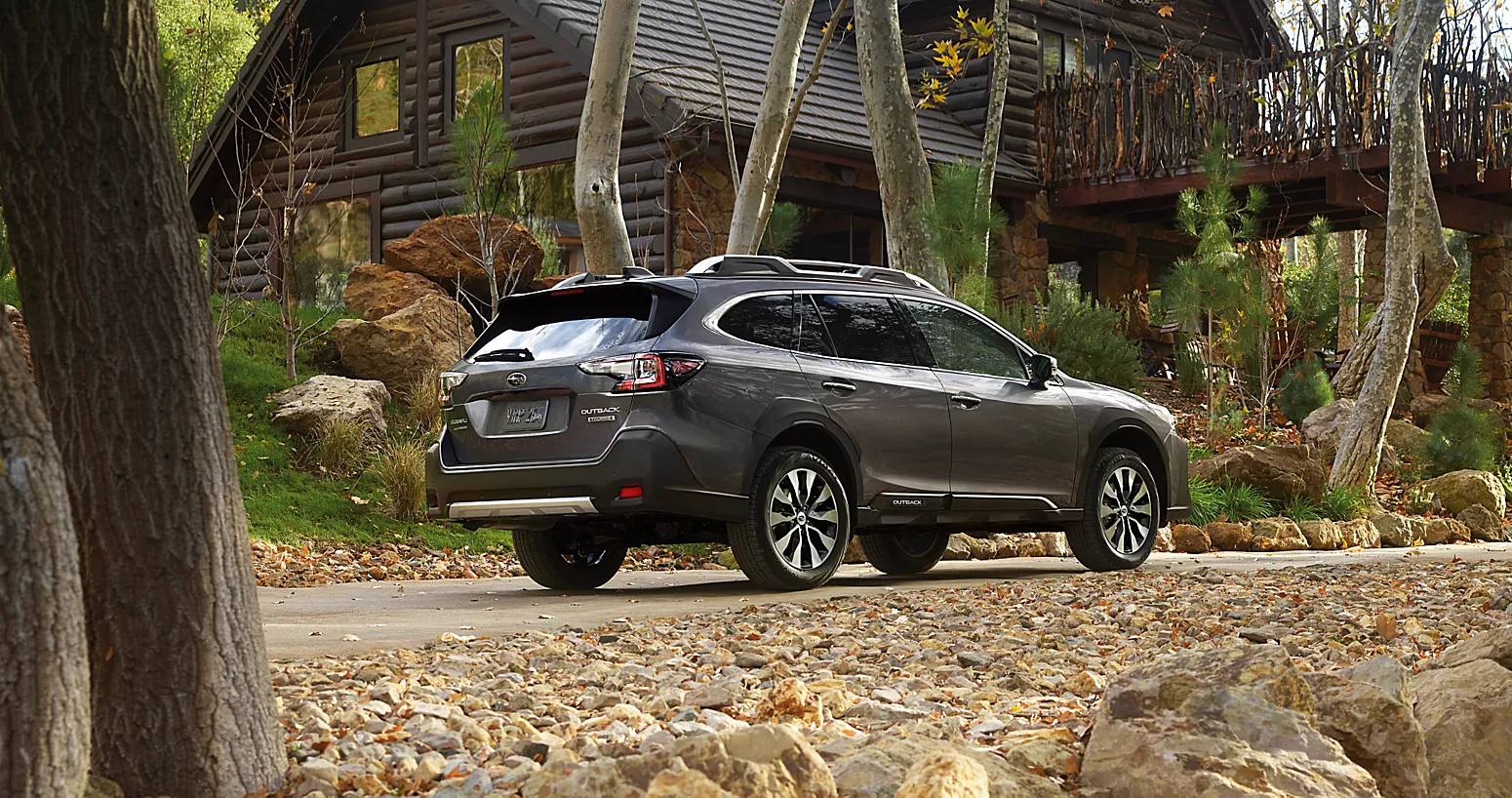 A silver suv sitting parked in front of a house.
