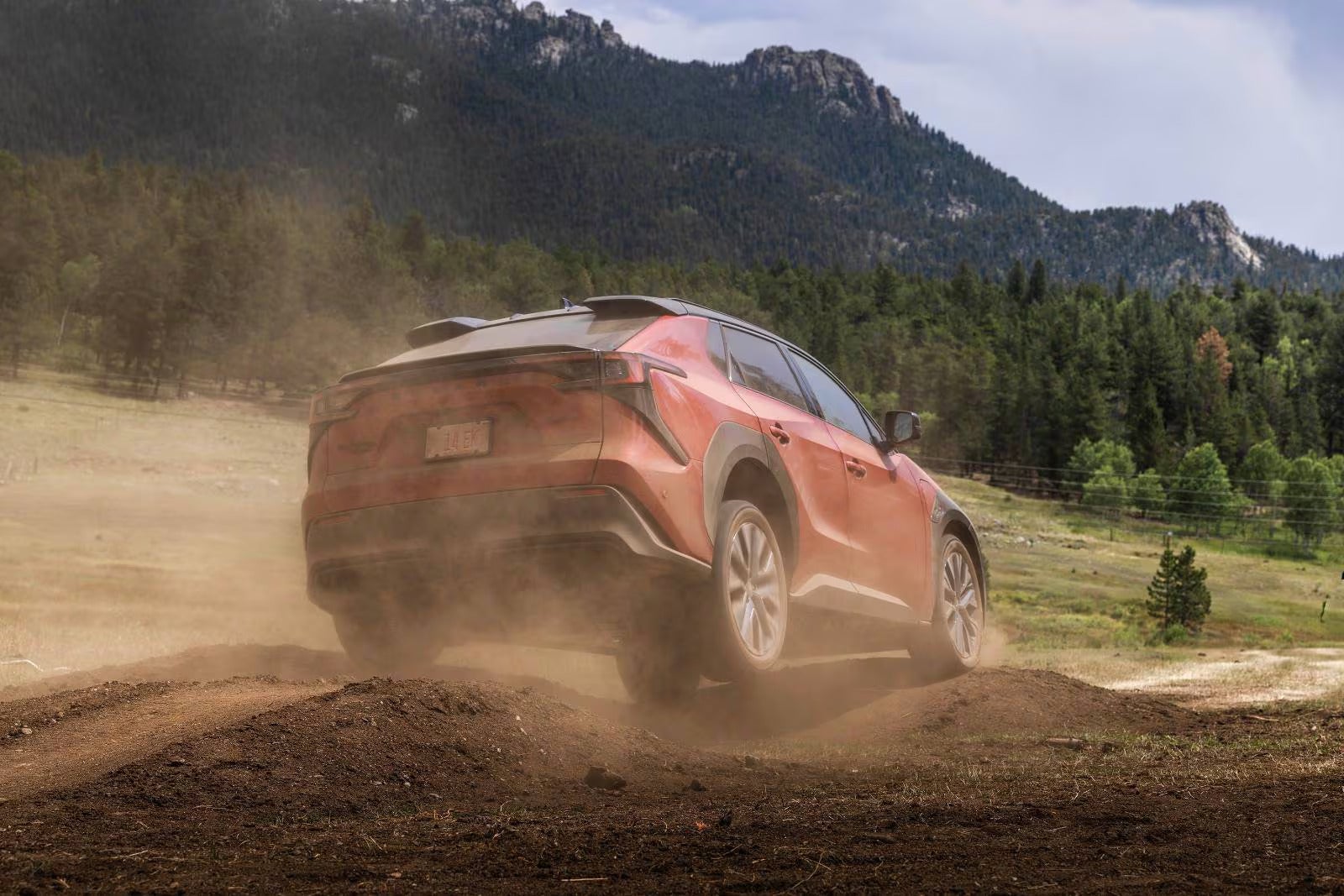 A red car driving off-road.
